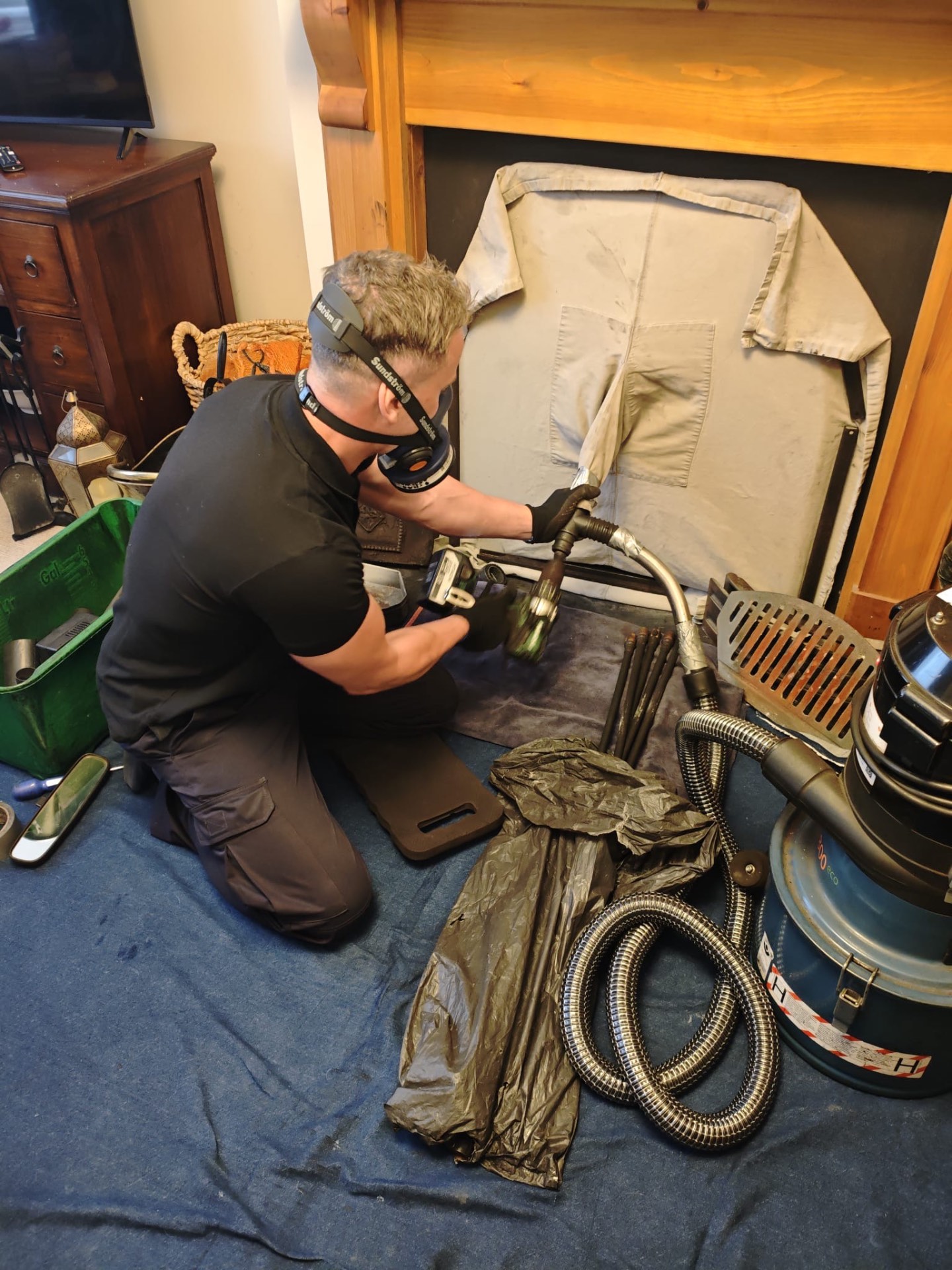 Chimney sweep at work on a Manchester rooftop